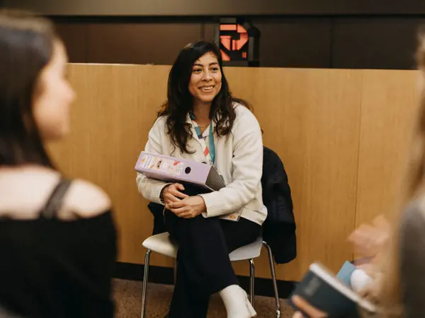 A woman working in science talking with students