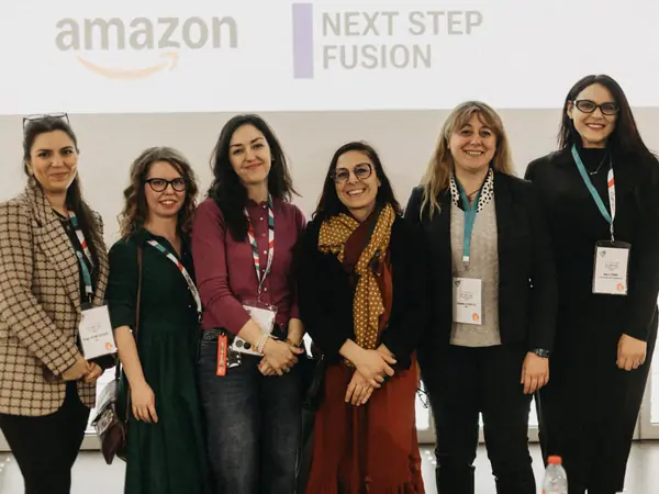A group of women in front of the sponsor screen