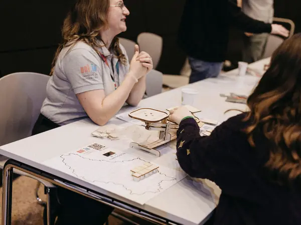 Students trying a hands-on activity at an exhibitor table