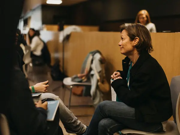 A scientist sitting with students and answering their questions