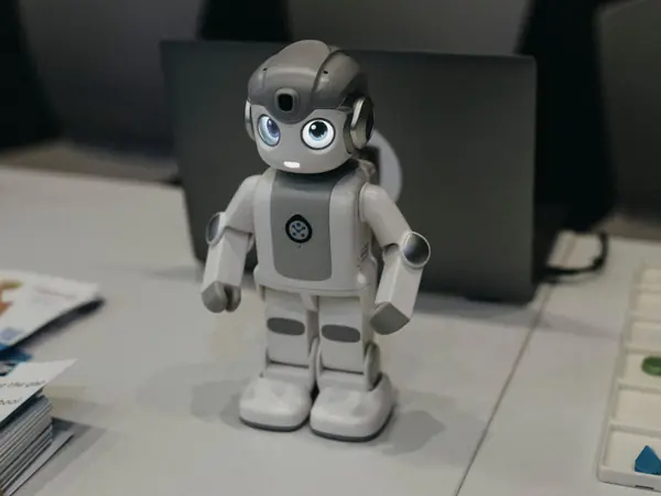 A small humanoid robot on an exhibitor table